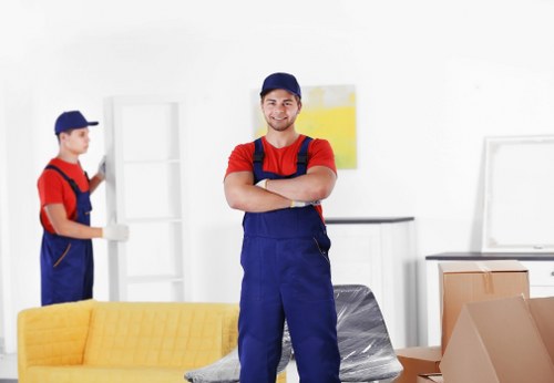 Trained movers handling furniture with protective equipment