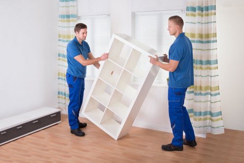 Movers carrying furniture through a property entrance