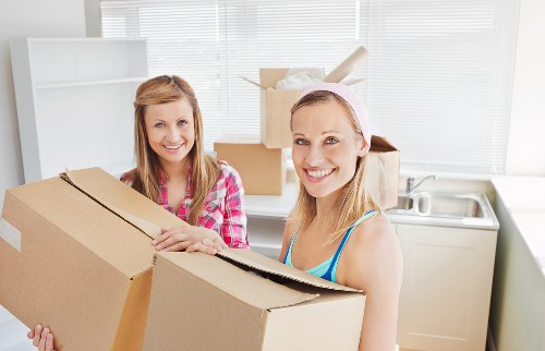 Careful loading of a piano into a removals vehicle for a local move